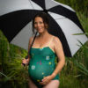 Pregnant lady with an umbrella modelling a swimming costume!