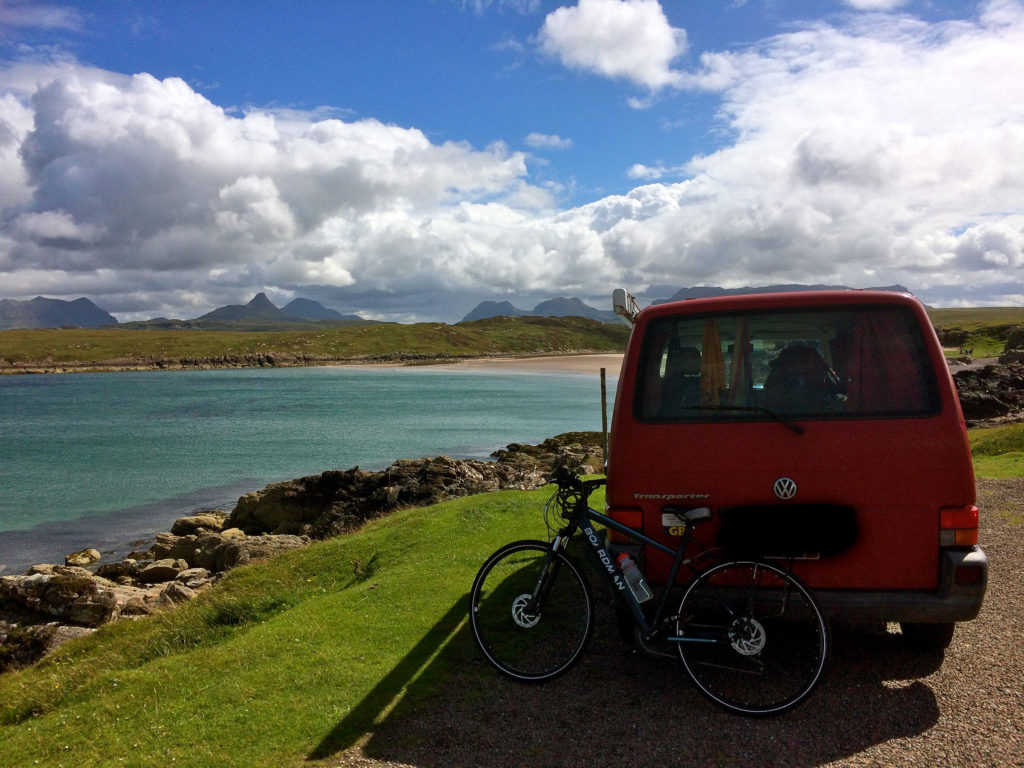 Red Campervan parked next to the sea, Achnahaird, Scotland