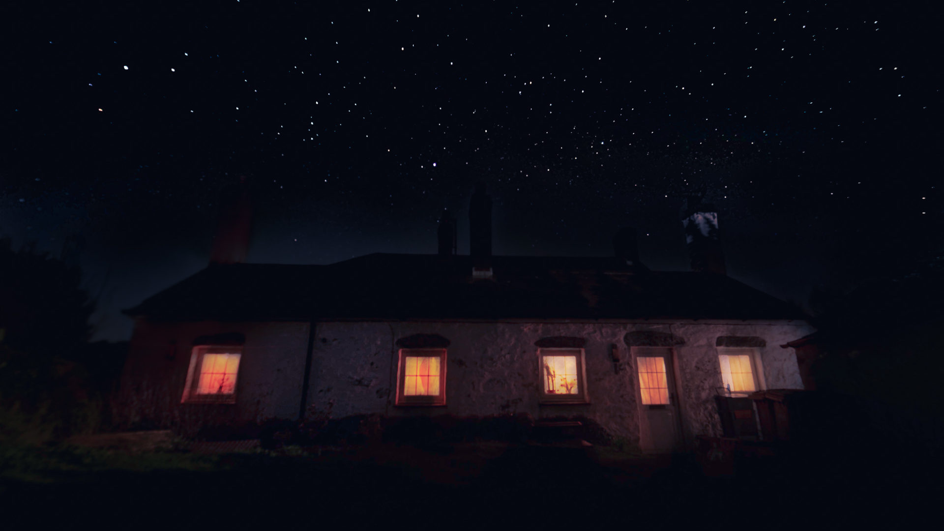 A photo of a cottage at night underneath the stars.
